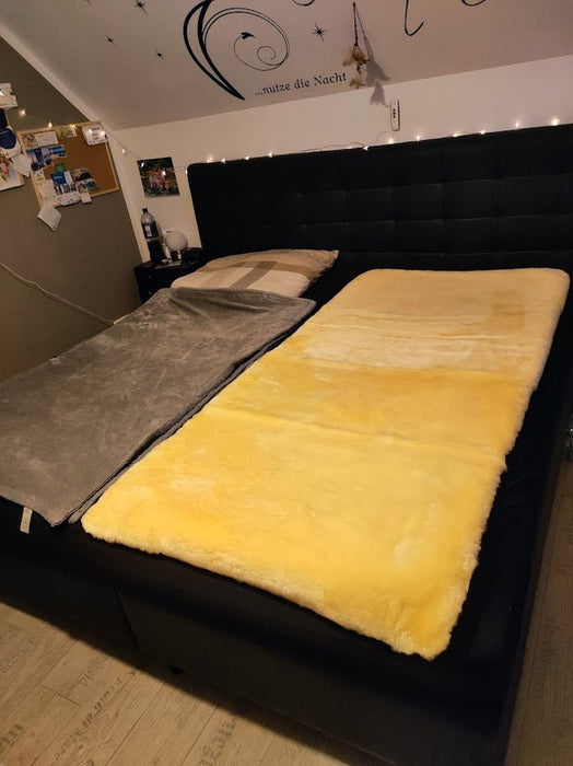 Lammfellunterbett - Schafland-Stock